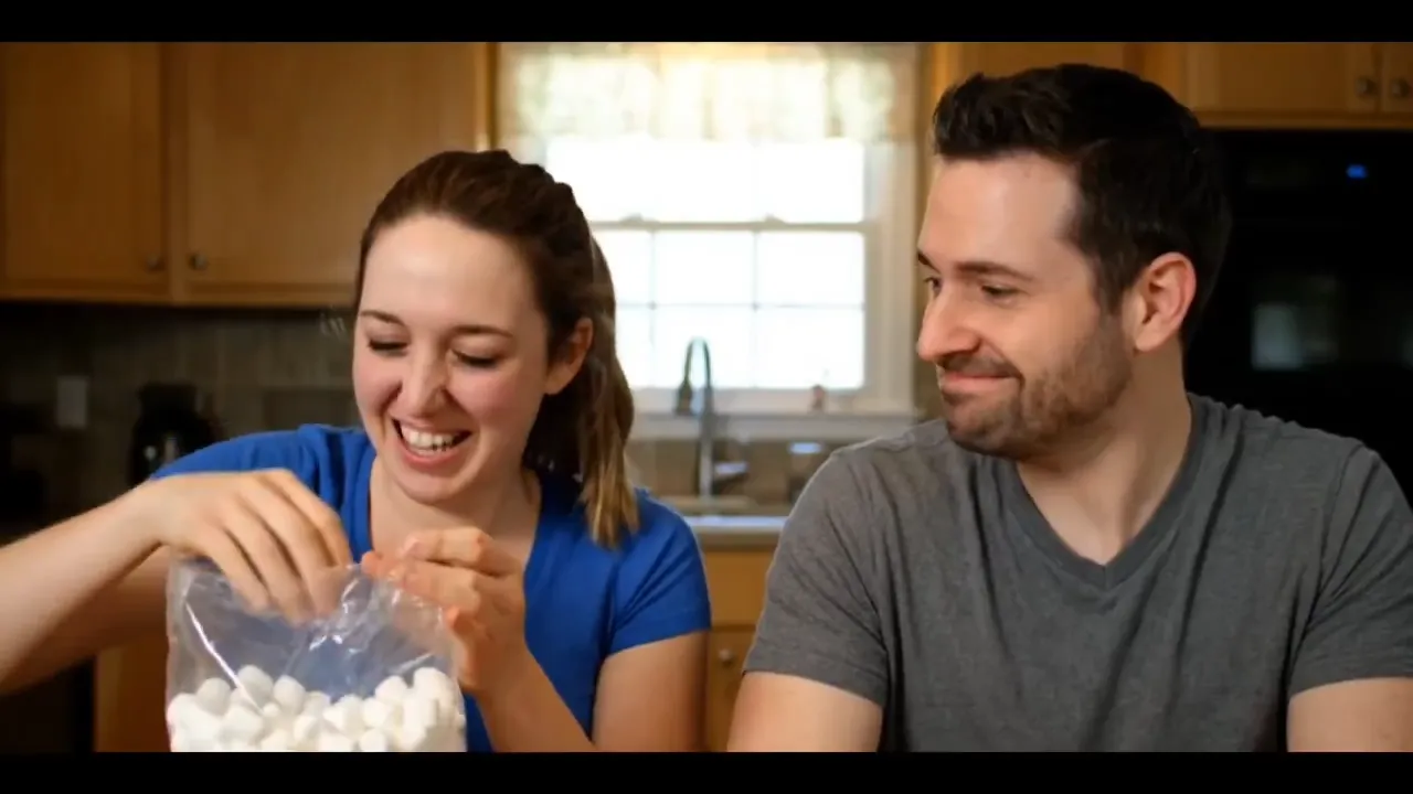 A woman shoves a handful of marshmallows in her mouth and tries to speak