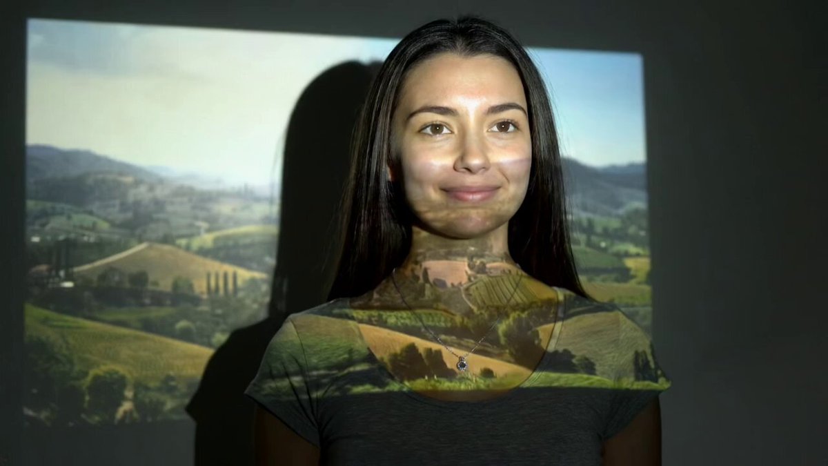 Movie is being projected directly onto young woman