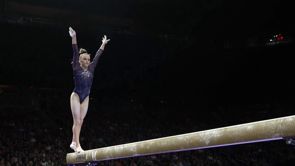 a gymnast flips on a balance beam. cinematic